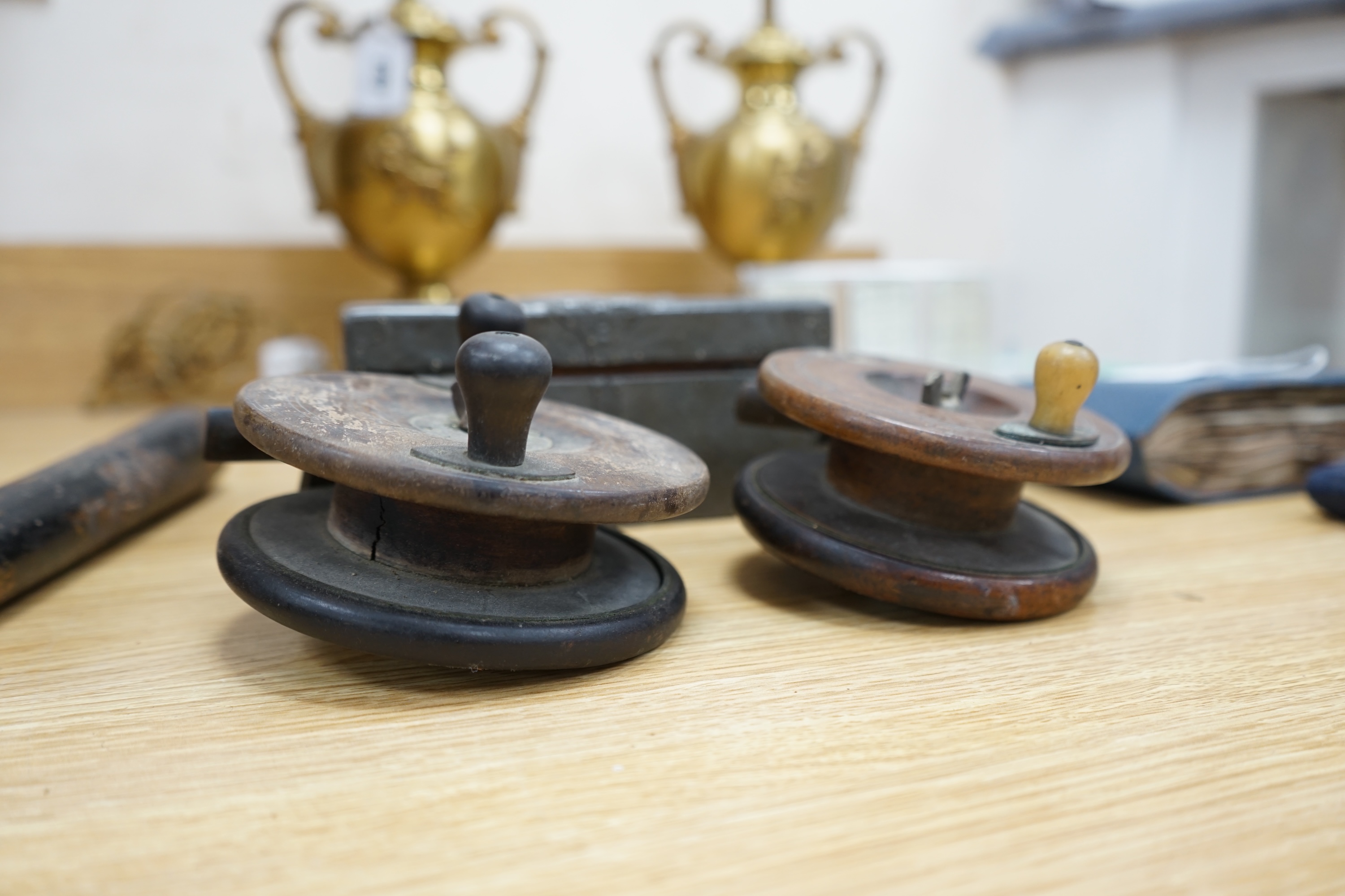 Two wooden fishing reels, a Victorian truncheon and an Arts and Crafts pewter box with enamel roundel. Truncheon 43cm long., Condition - all items worn